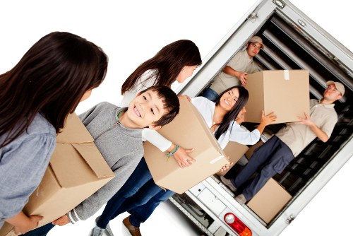 Moving home in Pimlico with packed boxes and removal van outside a London property