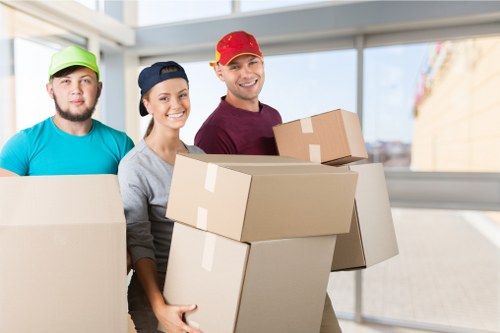 Packed boxes and furniture ready for collection by a removal van in Pimlico