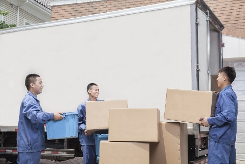 Professional removal staff using safety procedures inside a Pimlico property