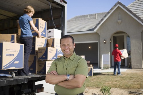Professional movers loading a piano for safe transit